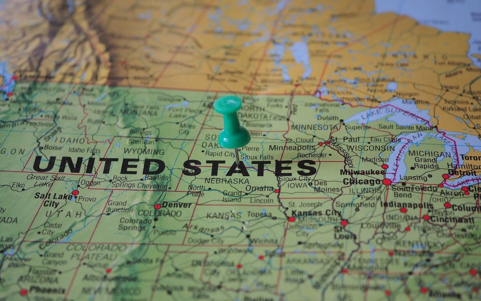 A green pushpin marks South Dakota on a map of the United States