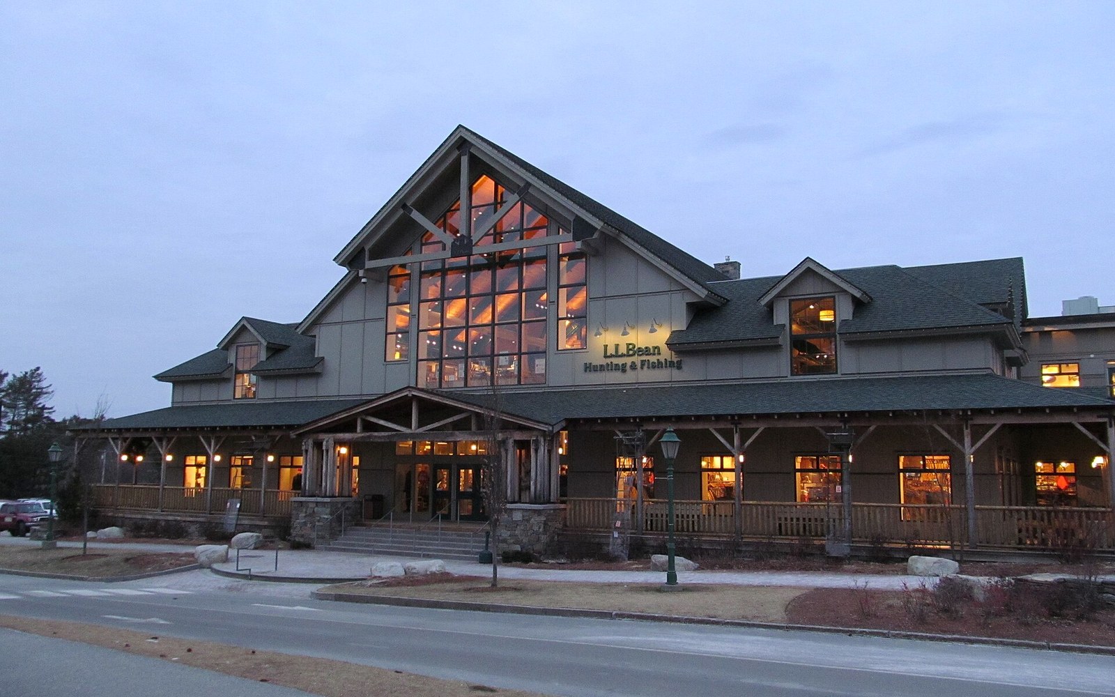 L.L.Bean Hunting & Fishing store lit up at dusk with peaked timber-frame gables