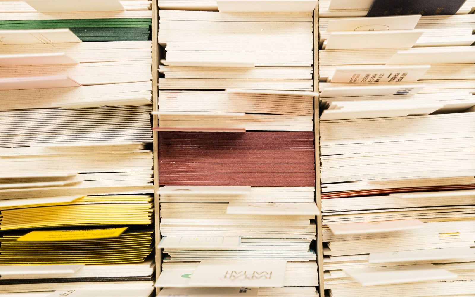 Stacks of paper and pamphlets with colored edges viewed from the side